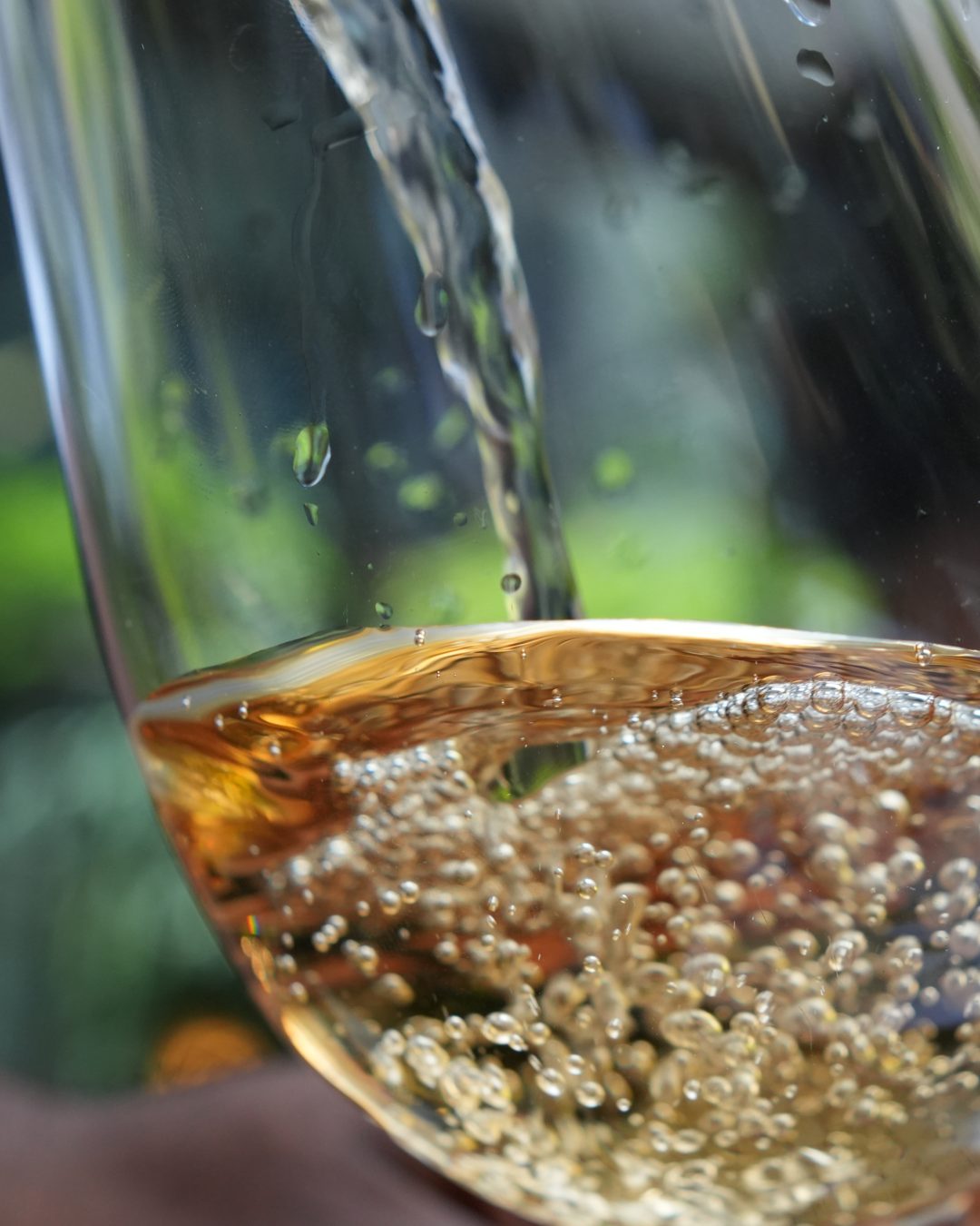 A glass of sparkling wine being poured at GIO